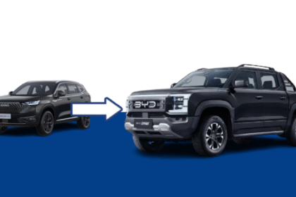 BYD Shark hybrid pickup truck parked off-road in rugged terrain