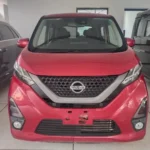"Nissan Dayz red kei car front view in Pakistan showroom 2025"