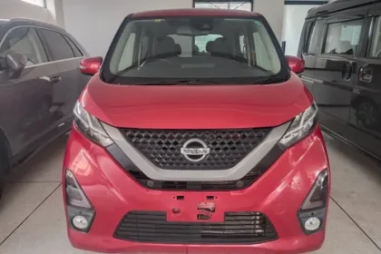 "Nissan Dayz red kei car front view in Pakistan showroom 2025"