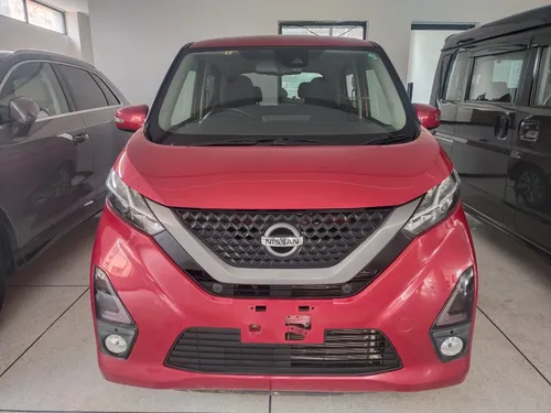 "Nissan Dayz red kei car front view in Pakistan showroom 2025"